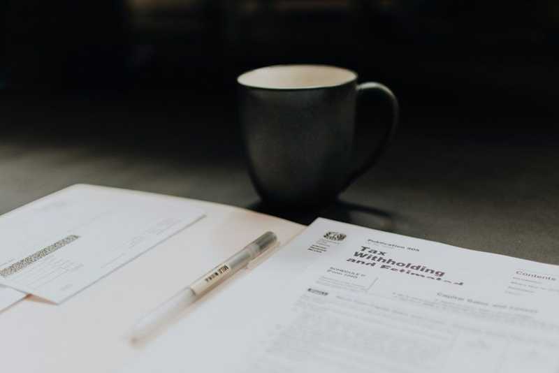 a black mug next to documents